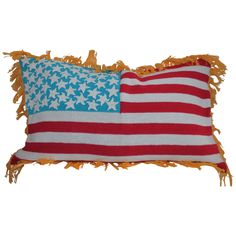 an american flag pillow with fringes on the bottom and one in red, white and blue