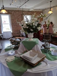 a table set up with plates, napkins and flowers