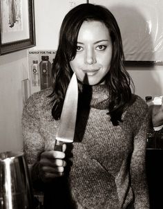 a woman holding a large knife in her hand