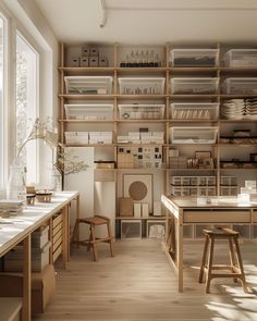 a room filled with lots of wooden shelves and white counter tops next to a window