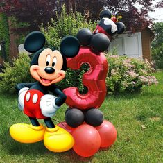 a mickey mouse balloon with the number 3 on it