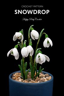 a potted plant with snowdrops in it