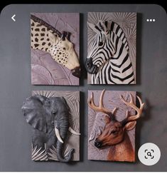 four different animal heads mounted to the side of a wall with zebras and giraffes on them