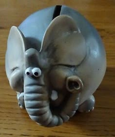 an elephant figurine sitting on top of a wooden table