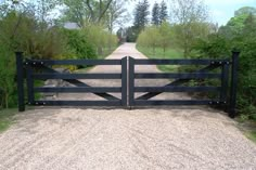 an open gate leading to a dirt road