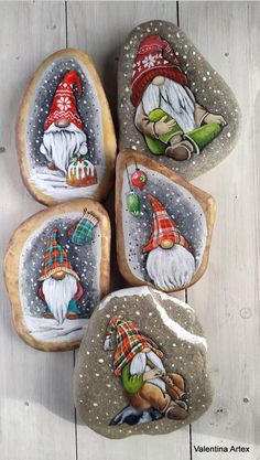 four painted rocks with gnomes on them