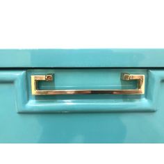 a close up of a blue drawer with brass handles