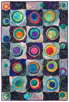 a quilt made with circles and squares