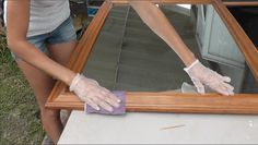 a woman in white gloves cleaning a window