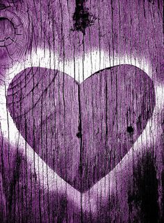 a heart painted on the side of a wooden fence with purple paint and wood shading