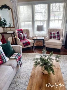 a living room with couches, chairs and a coffee table in front of a window