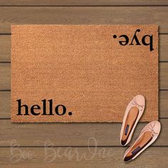 a pair of ballet shoes sitting on top of a door mat next to a pair of slippers