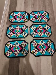 six pieces of quilted placemats sitting on the floor