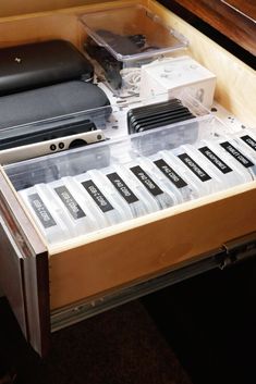 an open drawer with various electronics in it