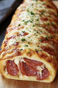 a cheesy pizza roll on a cutting board