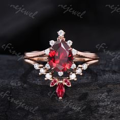 a ring with a large red stone surrounded by small white diamonds on top of it