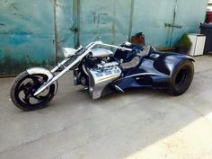 a motorcycle parked in front of a building with a side car attached to the bike