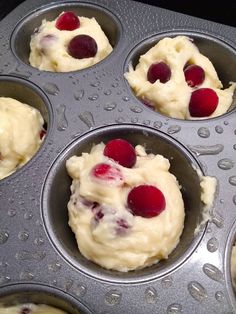 cupcakes with cherries in a muffin tin ready to go into the oven