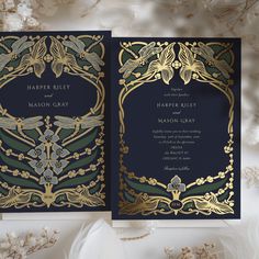 two wedding cards with gold and green designs on them, sitting next to each other