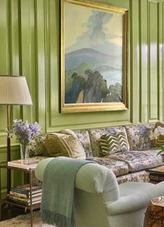 a living room with green walls and furniture