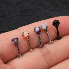 three different types of piercings are shown in the palm of someone's hand