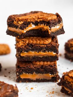 three chocolate brownies stacked on top of each other with caramel drizzle