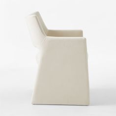 a white chair sitting on top of a white floor