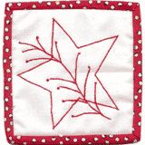 a red and white quilted square with an image of a bird in the center