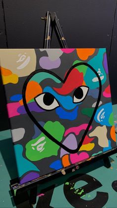 an art work is being displayed in front of a wall with numbers and hearts painted on it