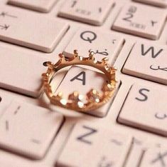 a gold ring sitting on top of a computer keyboard