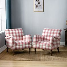 two red and white plaid chairs in front of a window