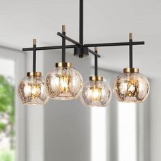 four lights hanging from a ceiling fixture in a living room