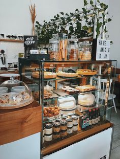 a display case filled with lots of different types of desserts and pastries in glass containers