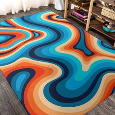 a colorful area rug in the middle of a living room with a book shelf and bookshelf