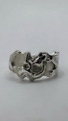 The fluid metal custom molten ring is a subtle and elegant addition to your ring stack. You can choose any word or letter combination (preferably under 6 characters due to space constraints). Whether it's your own name, a cheeky phrase or your partner's initials, let's make it happen! Each piece is one of a kind and meticulously hand carved from wax by me on the Sunshine Coast, Australia - I ship worldwide. PERSONALISED RING SPECIFICATIONS Metal: Recycled 925 sterling silver. Custom: Add your cu Melting Metal For Jewelry, Molten Metal Aesthetic, Silver Stackable Rings With Polished Finish, Wax Jewelry Carving, Unique Silver Stackable Rings With Polished Finish, Silver Hand Cast Rings For Everyday, Hand Cast Silver Rings For Everyday, Hand Cast Silver Rings For Everyday Wear, Symbolic Hand Cast Silver Engraved Ring