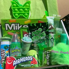 a green bag filled with lots of different items