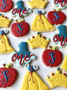 decorated cookies are arranged in the shape of princess's dresses and apple for birthdays