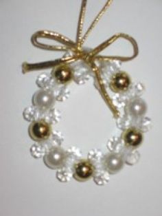 a gold and white beaded wreath ornament