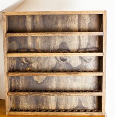 an old wooden bookcase with holes in the bottom and two shelves on each side