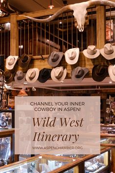 the inside of a cowboy shop with hats hanging from the ceiling