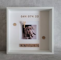 a photo frame with a dog's face and name written on the front in wooden letters