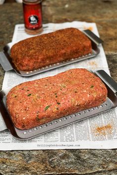 two meatloafs sitting on top of newspaper next to each other