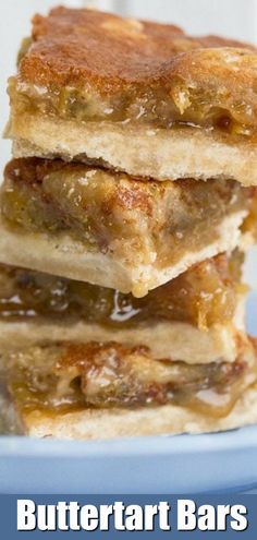 three pieces of cake sitting on top of a blue plate with the words butter tart bars