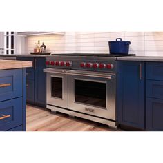 a kitchen with blue cabinets and an oven