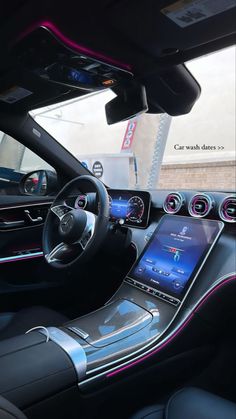 the interior of a car with various electronic devices and dashboard lights, including an iphone