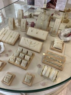 an assortment of jewelry on display in a glass case