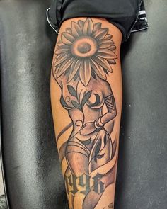 a woman with a sunflower tattoo on her leg