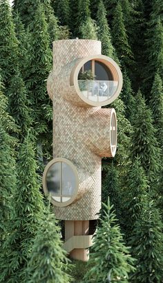 a tree house in the middle of some trees with two round windows on each side