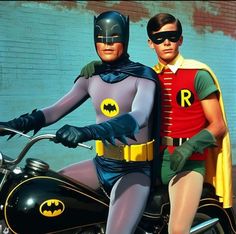 two men dressed as batman and robin wayne on a motorcycle