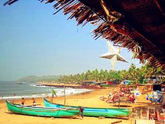 a beach with boats and people on it